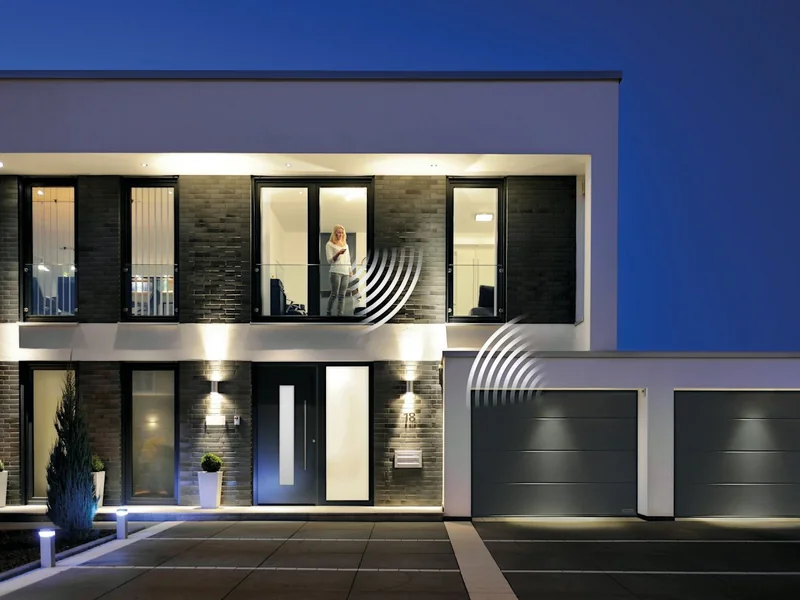 House at night with automatic garage doors closed