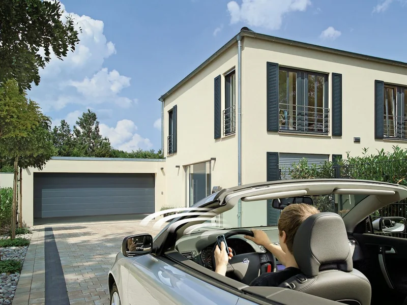 Automatic sectional garage door opening for a car on a driveway